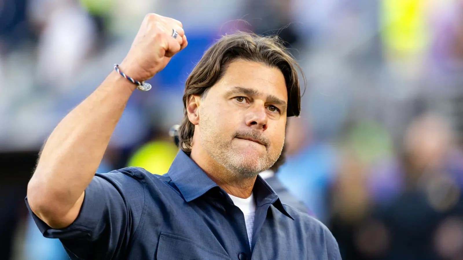 Coach celebrating with a raised fist on the field