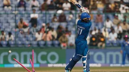 Batsman hitting the ball, stumps dislodged