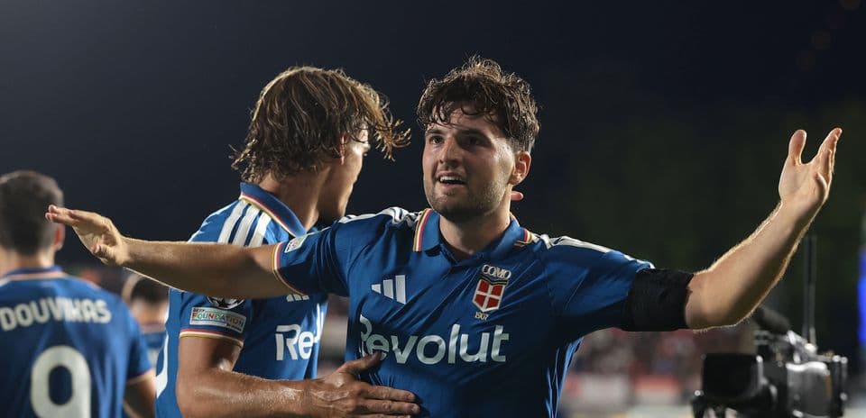 Player celebrating a goal with teammates on field