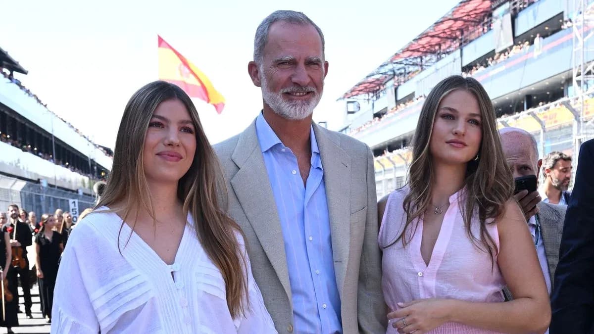 Three people posing at a racing event venue