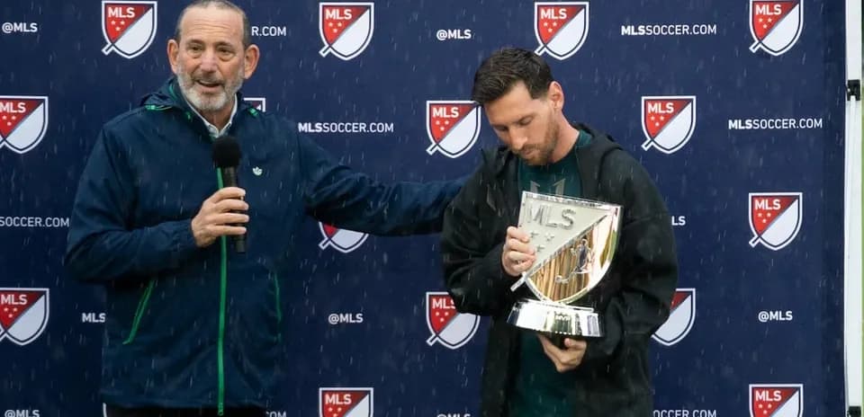 Player receiving trophy during rainy award ceremony