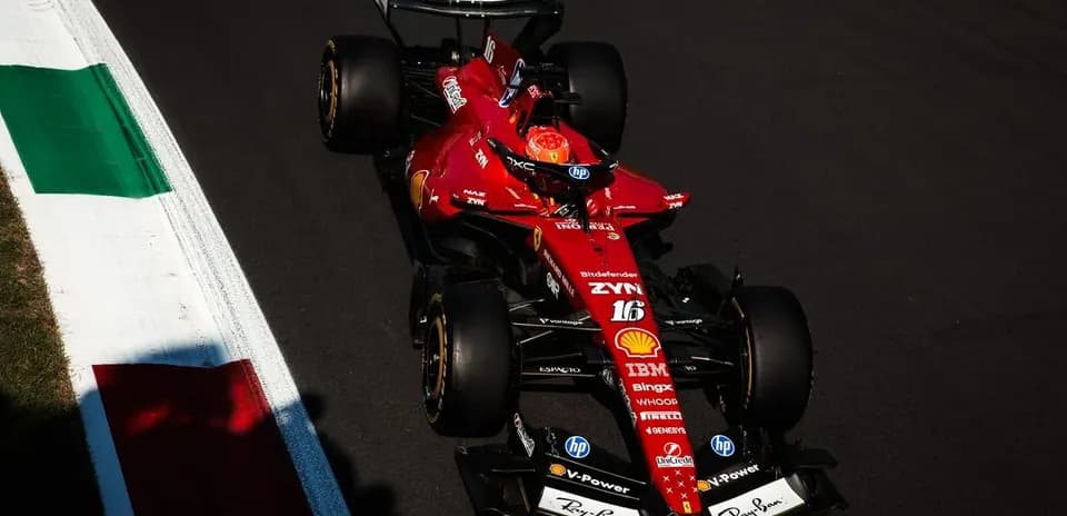 Ferrari F1 car racing on track with Italian flag
