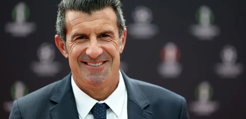 Man smiling in a suit at an event