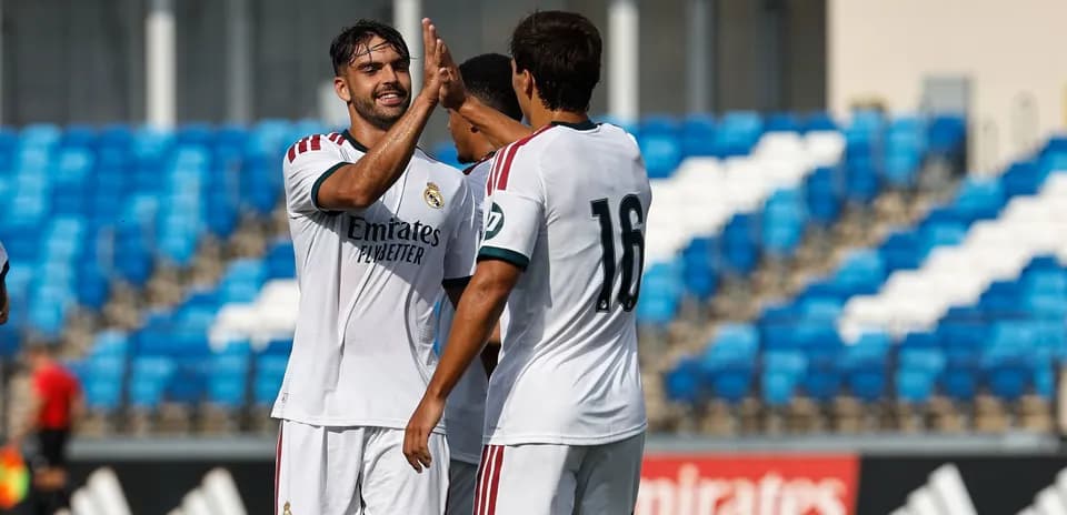 Two Real Madrid players celebrating a goal together
