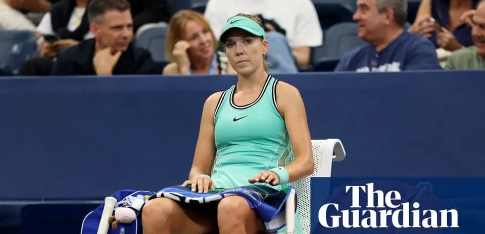 Tennis player seated on bench during match