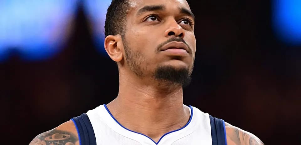 Player in Dallas Mavericks jersey looking upward