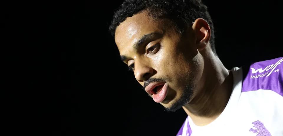 Player with focused expression during post-match interview
