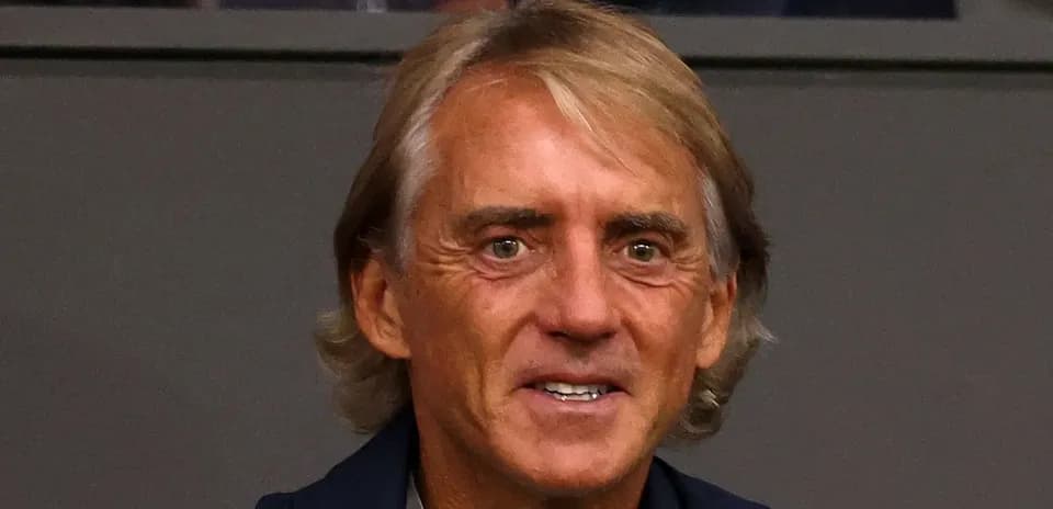 Coach sitting in the stands during a match