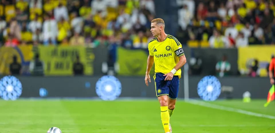 Player in yellow jersey with captain's armband on field