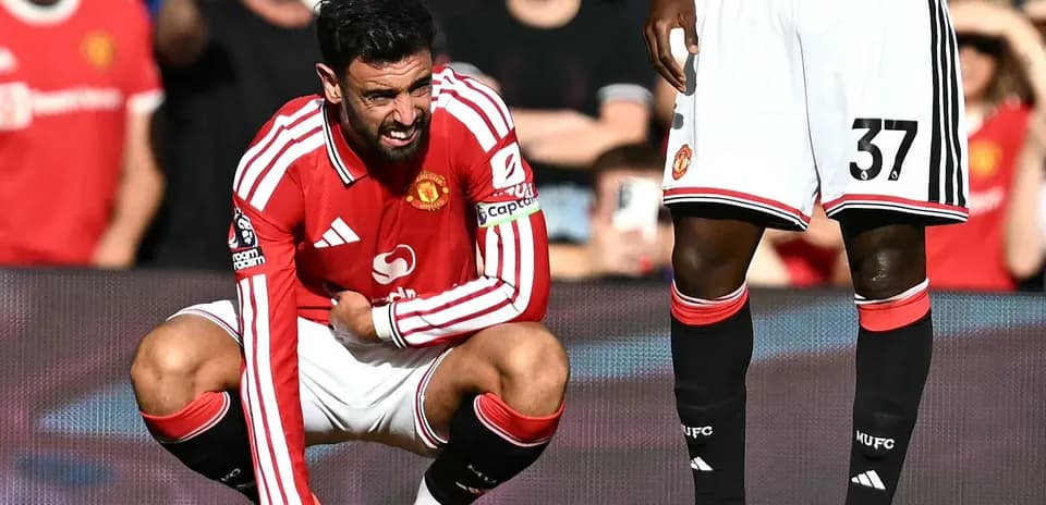 Bruno Fernandes crouching in pain during match