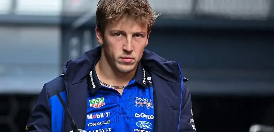 Driver walking in team jacket with drink
