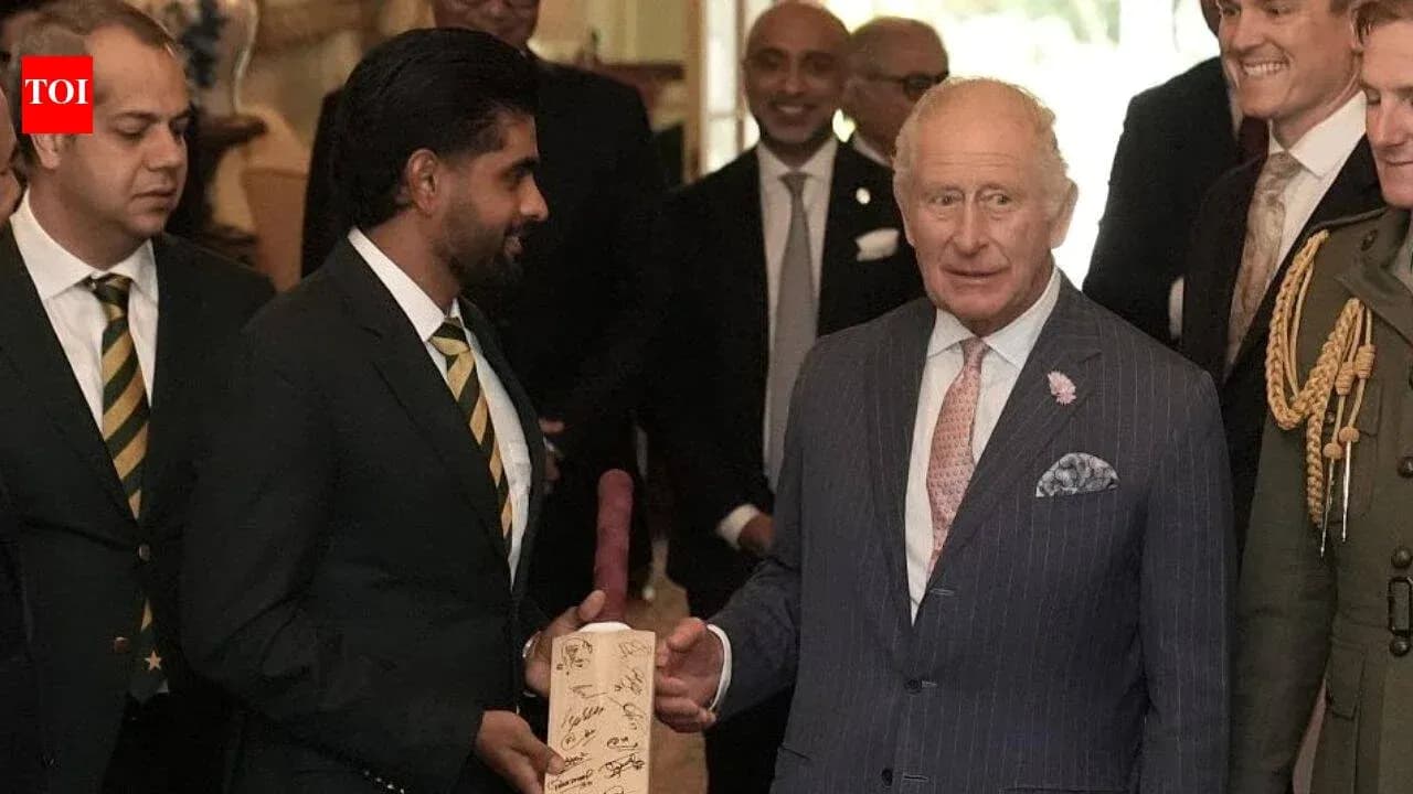 Cricket team presenting signed bat to King Charles