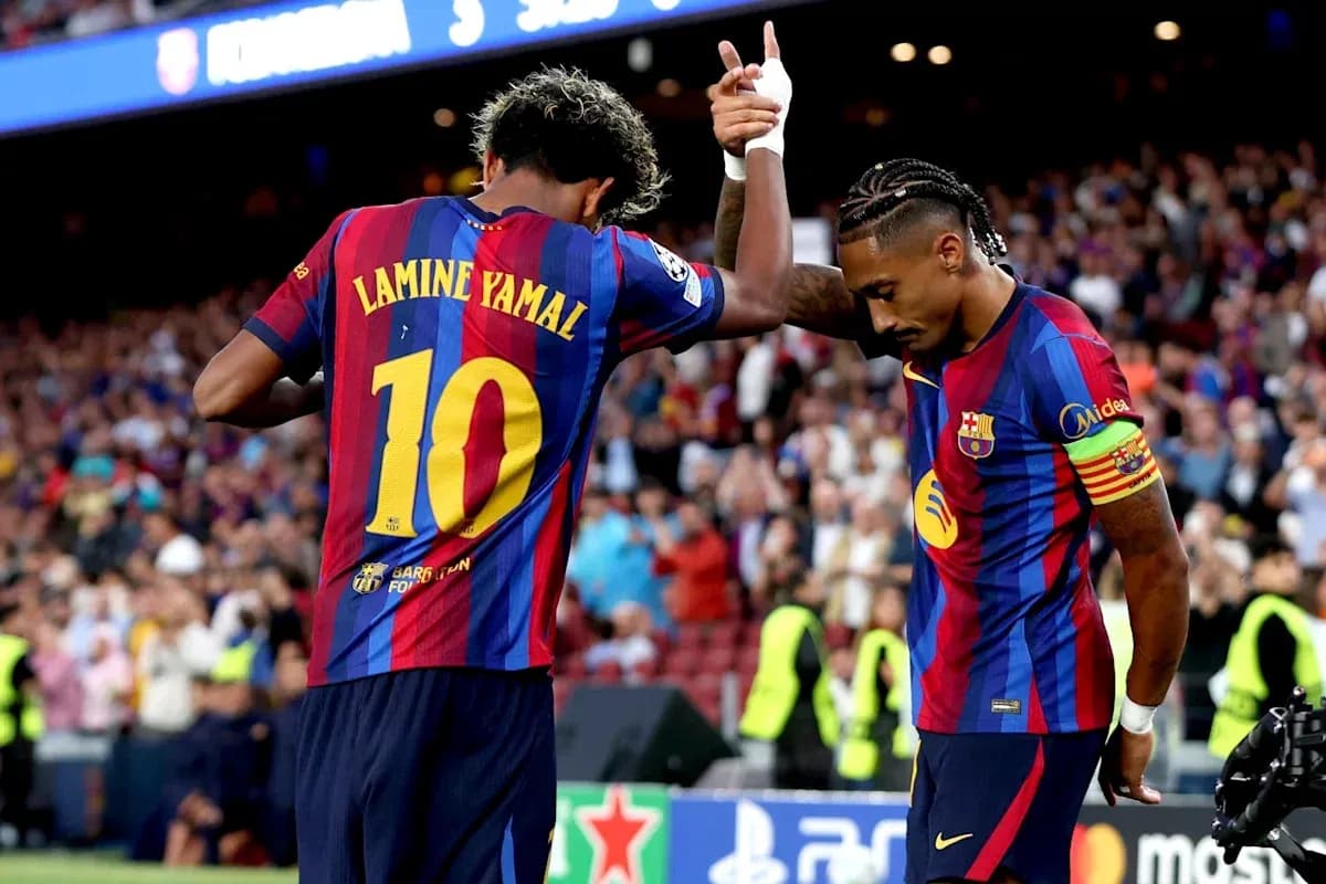 Two FC Barcelona players celebrating a goal