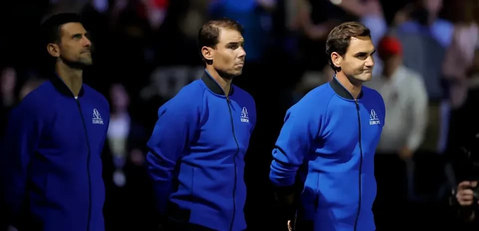 Three tennis players in blue jackets on stage