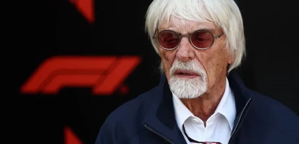 Man with white hair and glasses at F1 event