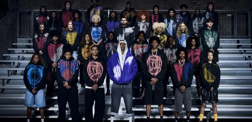 Group of young individuals posing in colorful hoodies
