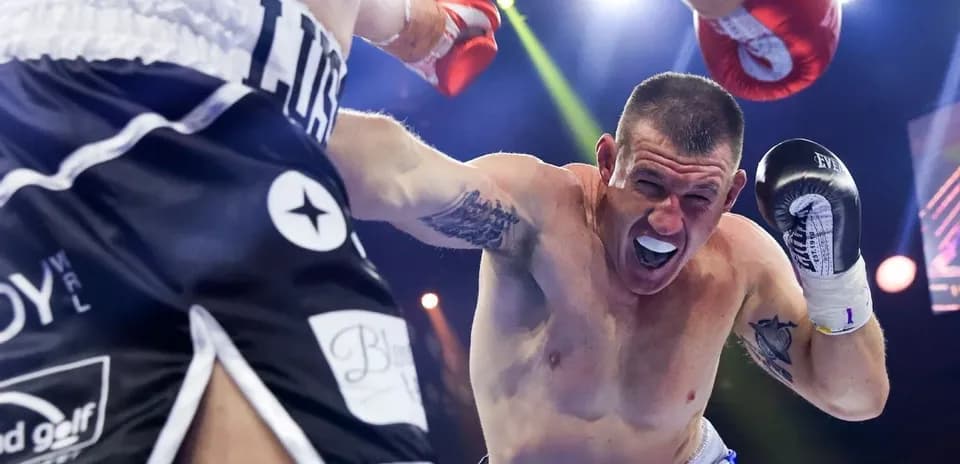 Boxer dodging a punch during a match