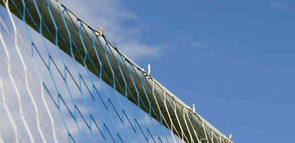 Close-up of a soccer goal net and post