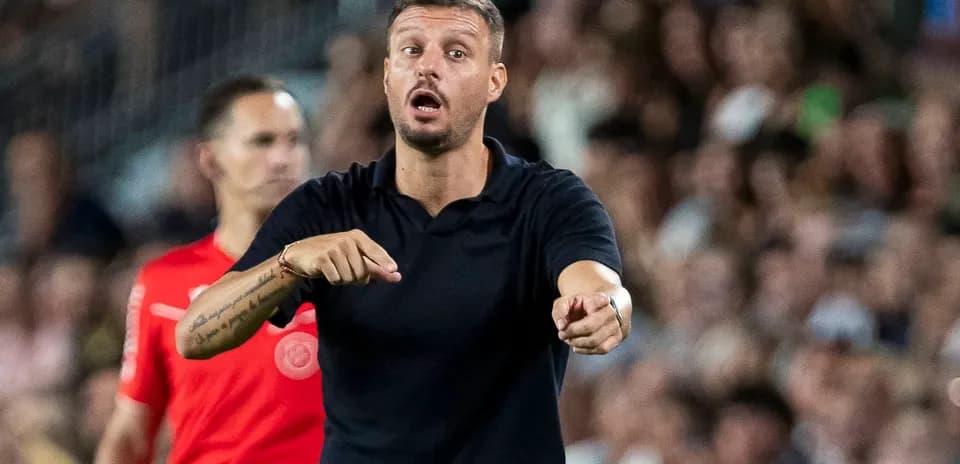 Coach directing players during a match on sideline
