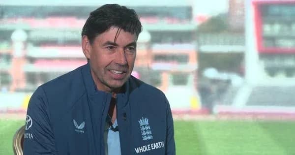 Man in England cricket team jacket during interview