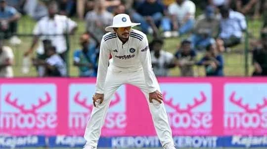 Cricketer fielding in front of a crowd