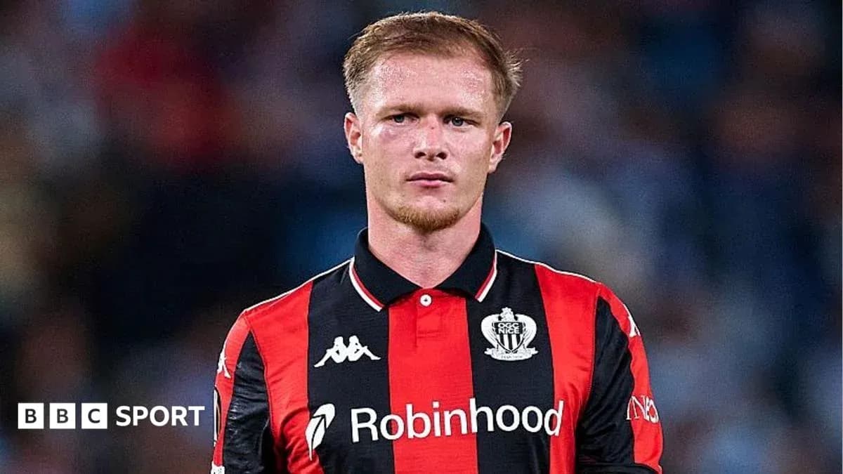 Player in black and red jersey on field