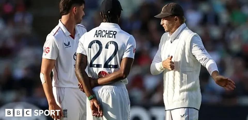 England players discussing strategy on the field