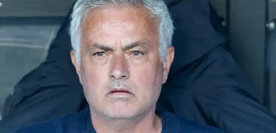 Manager sitting in dugout during match