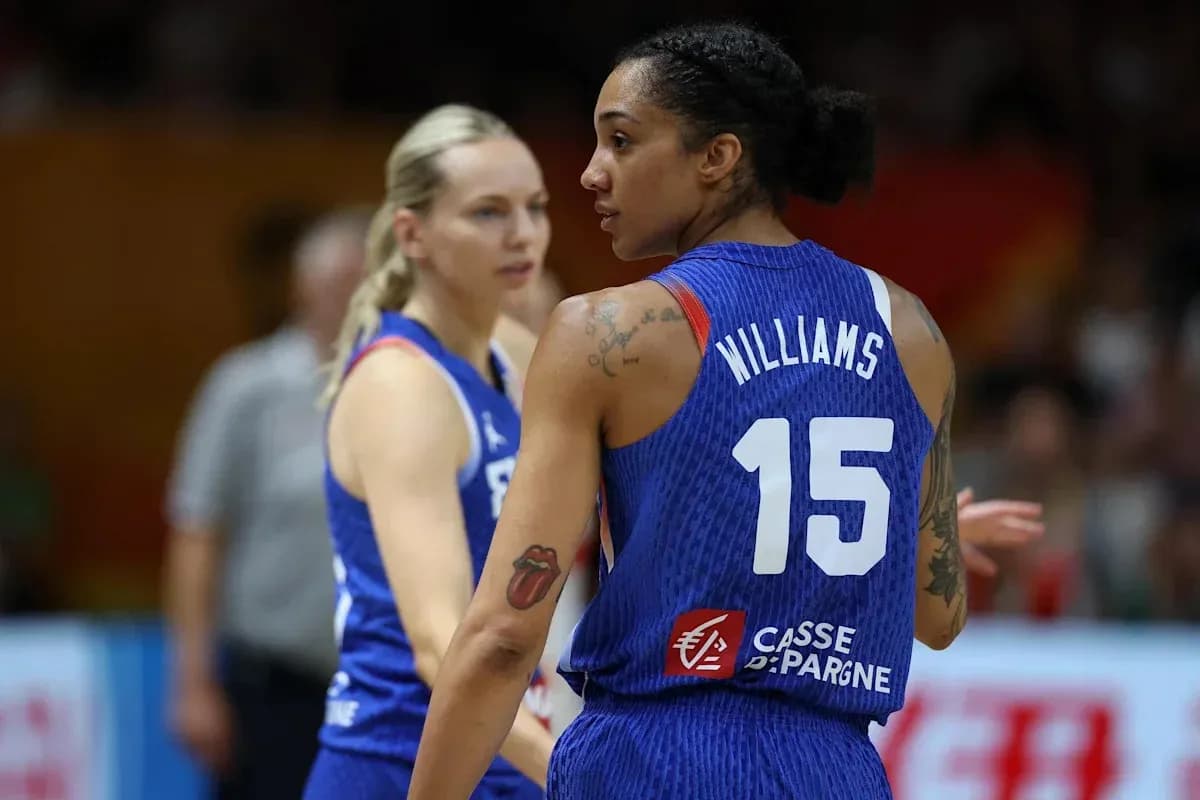 Two basketball players in blue uniforms on court