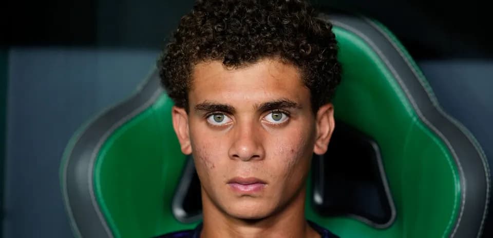 Young player seated on green gaming chair