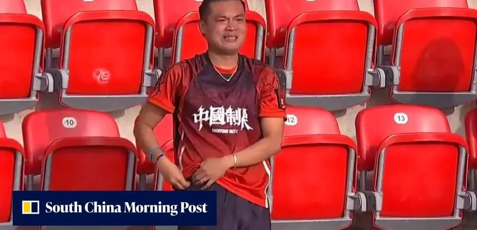 Fan wearing team jersey in empty stadium seats
