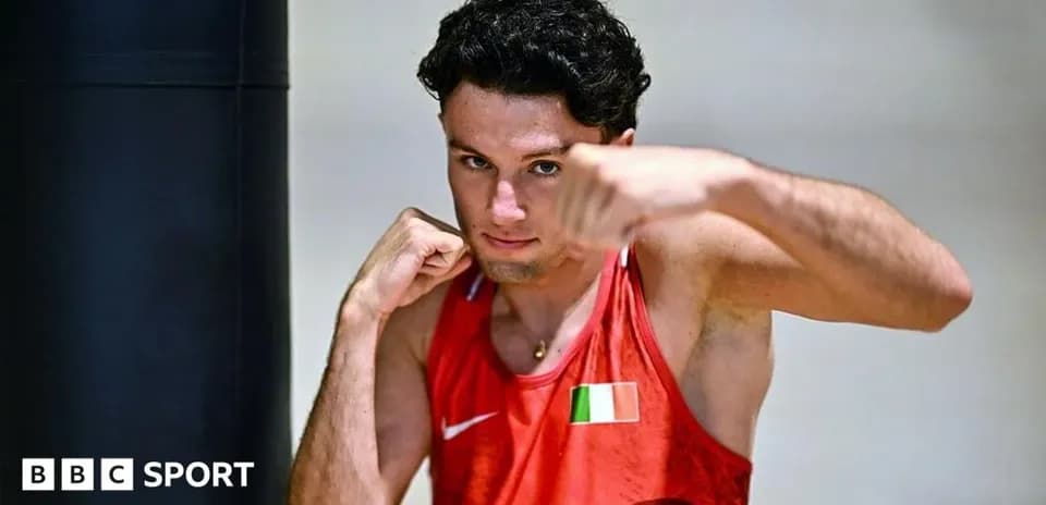 Boxer posing with gloves in training facility
