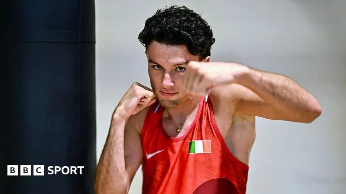 Boxer posing with gloves in training facility