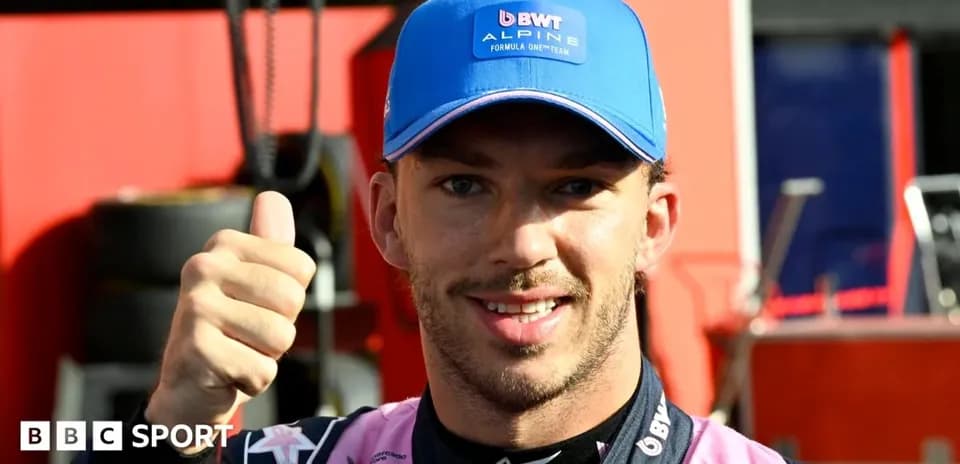 Driver giving thumbs up in team garage