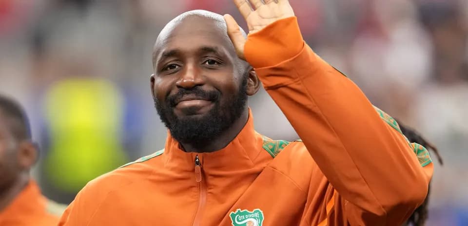 Player waving while wearing Cote d'Ivoire tracksuit