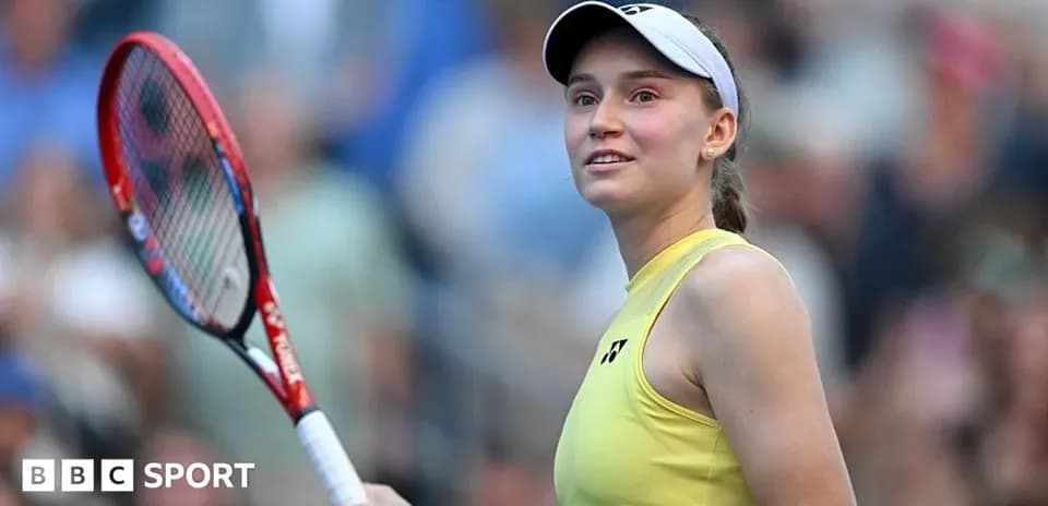 Tennis player holding racket and smiling at crowd