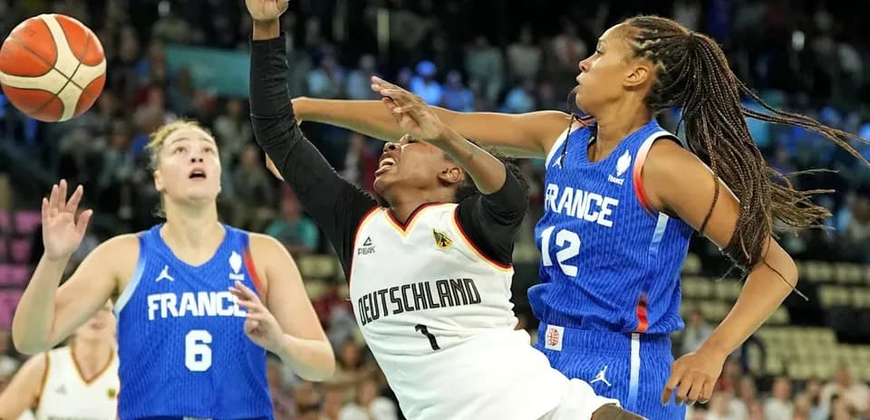 Players contesting for the ball during a basketball match