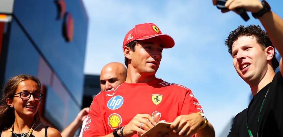 Driver interacting with fans outside team garage