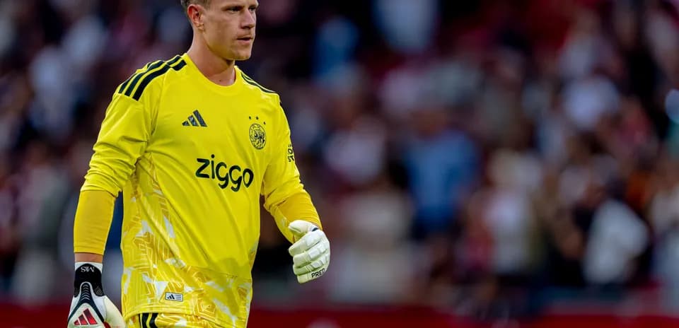 Goalkeeper in yellow jersey walking on the pitch