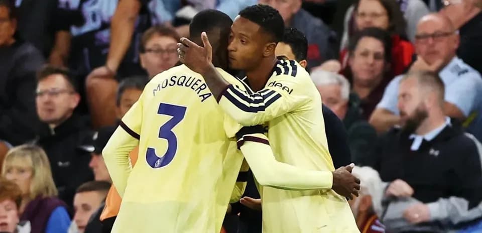Players embracing on the sidelines during a match