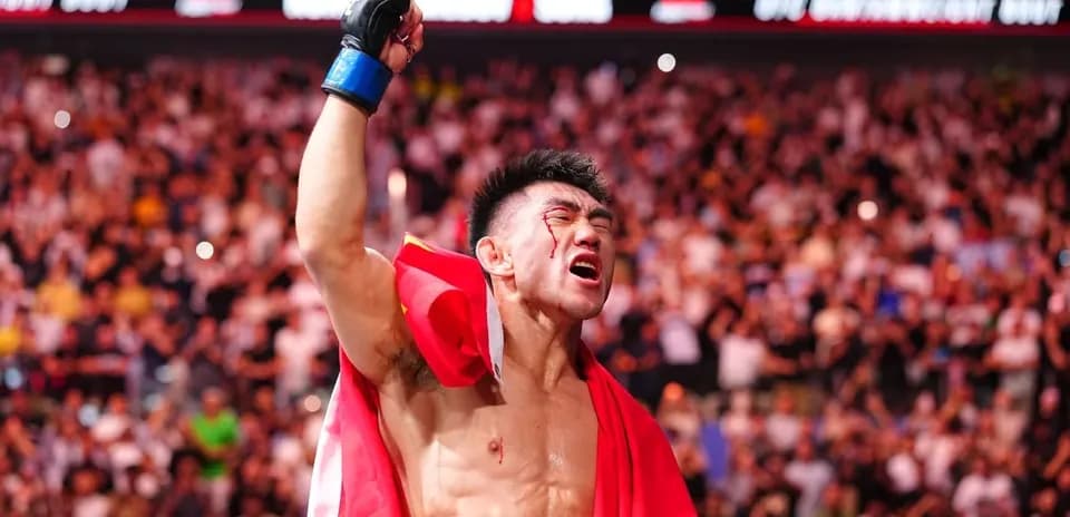 Fighter celebrating victory with flag after match