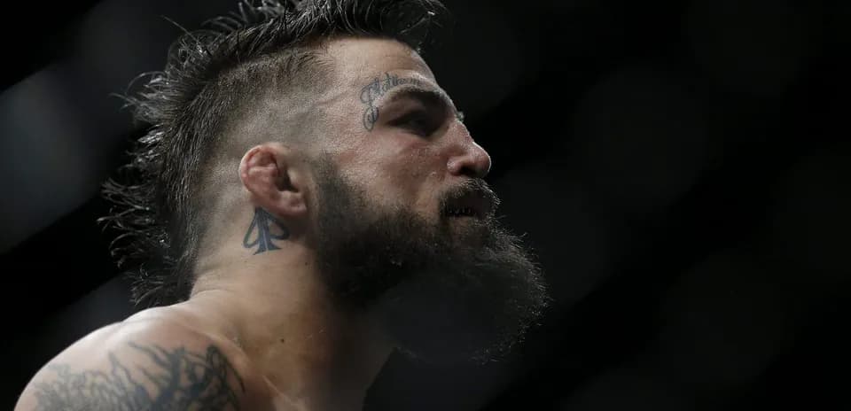 Close-up of a fighter with tattoos in profile