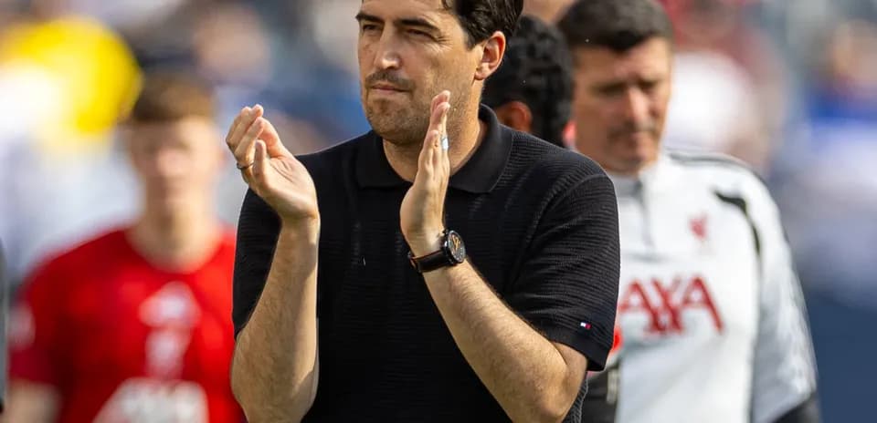 Coach applauding during match with team in background