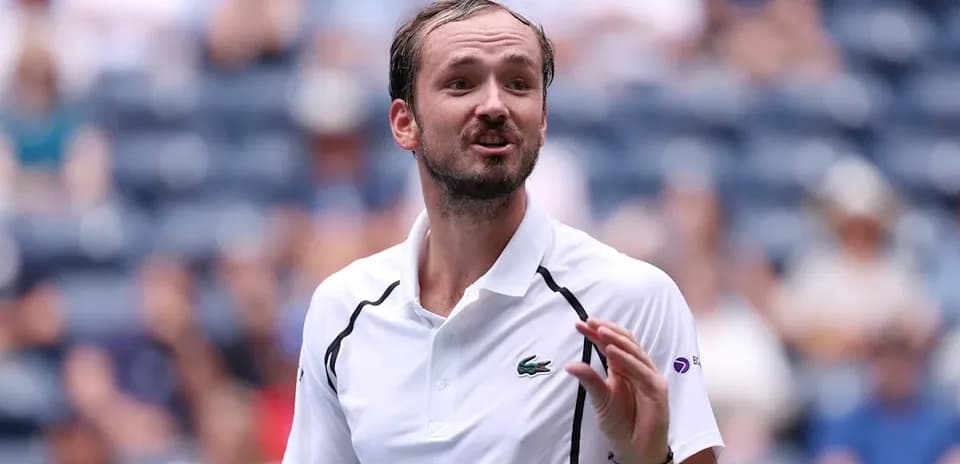 Tennis player gesturing during match on court