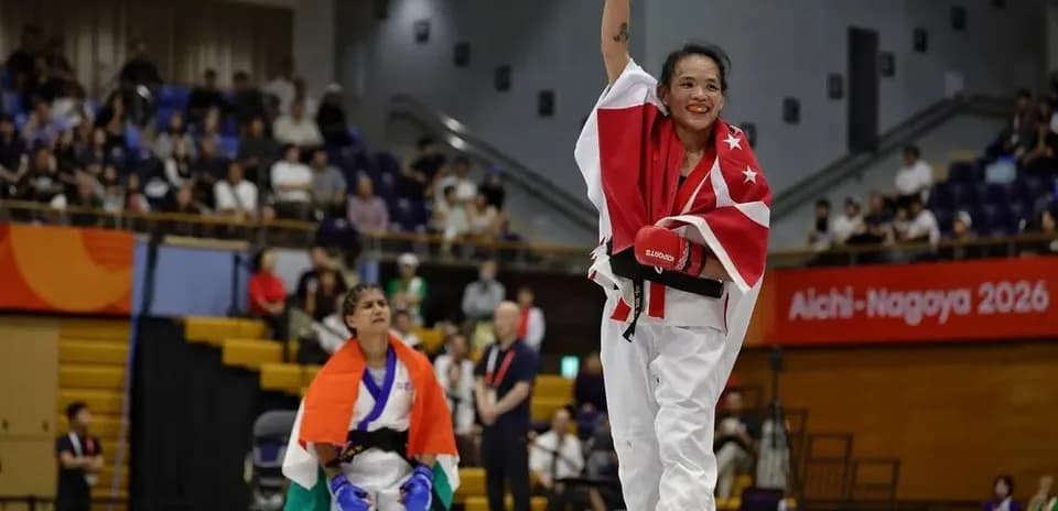 Winner celebrating with raised arm in karate match