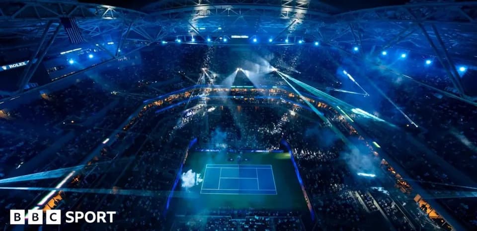 Night view of tennis stadium with lights and crowd