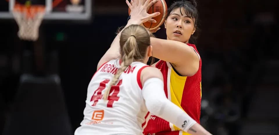 Player preparing to pass the basketball during game