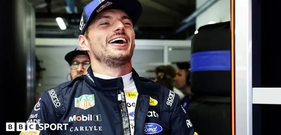 Driver smiling in team garage during event