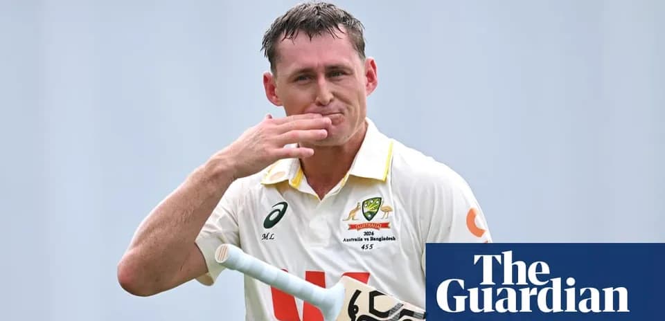 Cricketer acknowledging the crowd with bat in hand