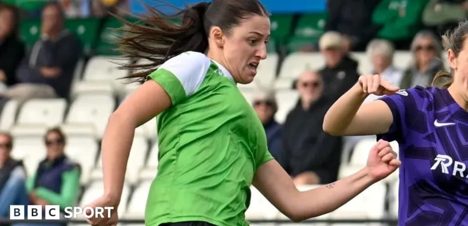 Player in green jersey dribbling past opponent in purple